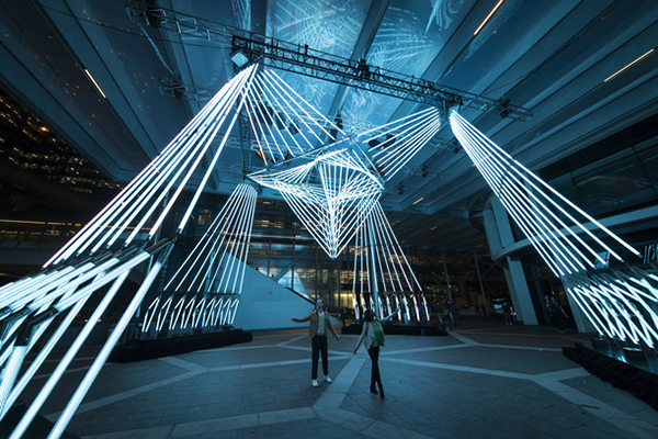 Couple enjoying the 'Chronoharp' light installation at Barangaroo during Vivid Sydney 2022...Artist: Amigo & Amigo..Collaborators: Otis Studios