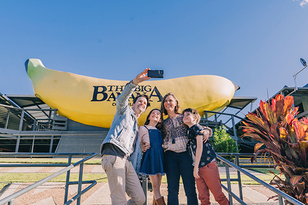 A family on holiday with kids, visiting the Big Banana at Coffs Harbour. Image credit: Destination NSW