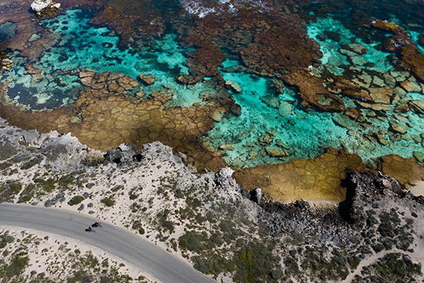 Young couple riding bikes along Rottenest Island bike paths