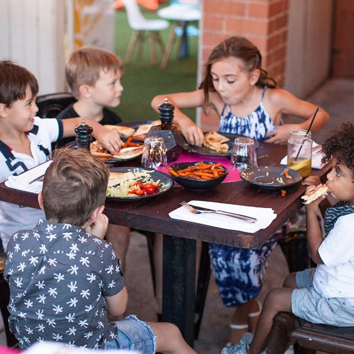 Children eating at BSKT Cafe in Nobby Beach.