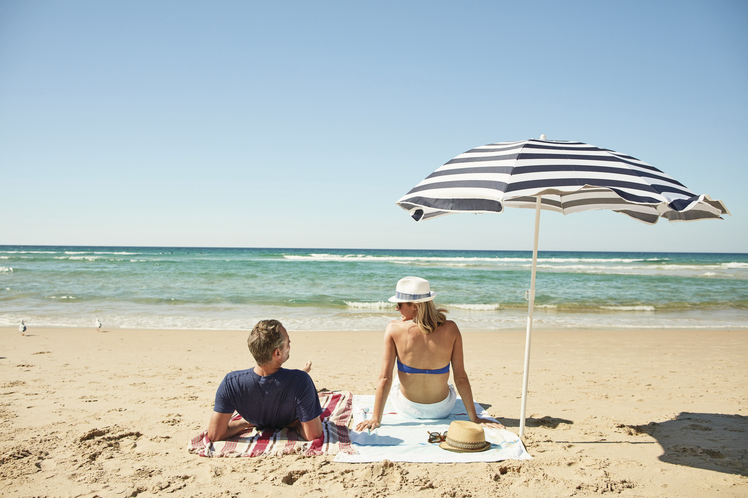 couple sunbathing on beach 