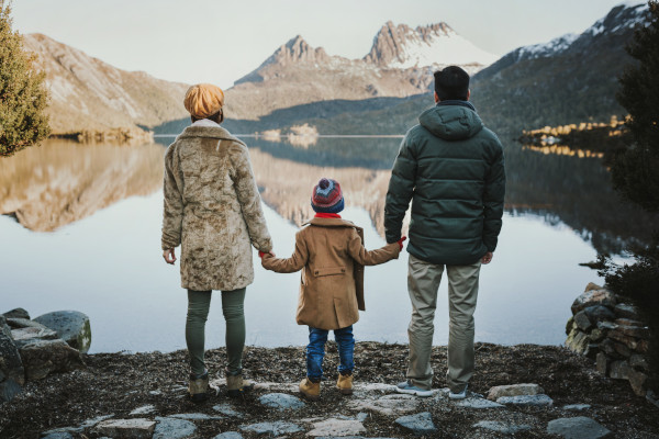 A family enjoying the views of the impressive holiday destination in Australia, Cradle Mountain. With some of the most serene landscapes in all of Australia, Cradle Mountain stands out for anyone planning an Australian holiday. Image credit: Laura Helle