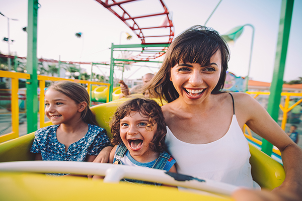 mother and daughters on a theme park ride 