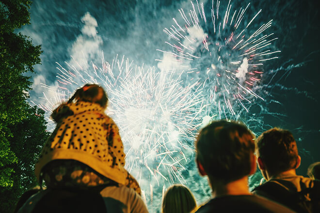 family enjoying evening fireworks 