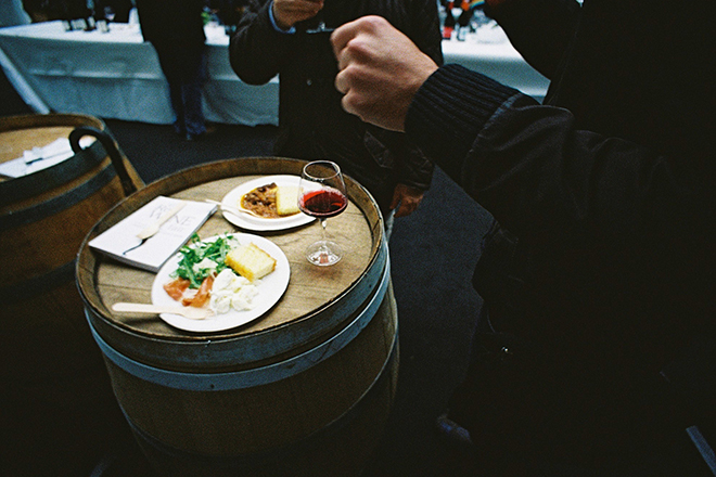 Drinks and food resting on an old wine barrel