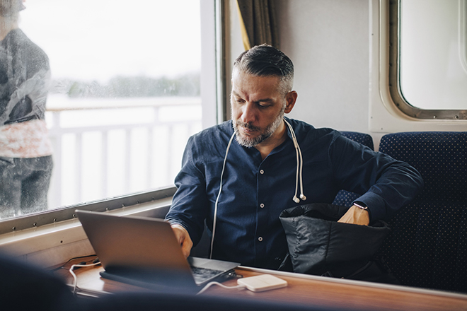 Man working on train during bleisue holiday 