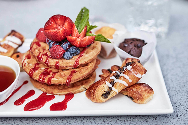 Indulgent breakfast of pastries and waffles at Novotel Cairns Oasis Resort