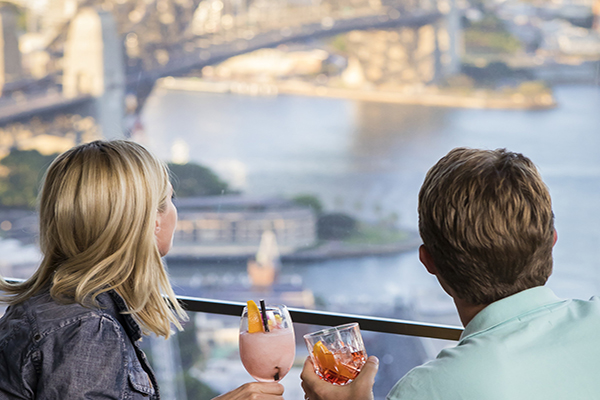 Couple enjoying food and drink with a view at O Bar and Dining, Sydney
