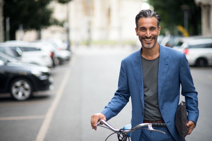 Fit man in blue suit with bicycle 
