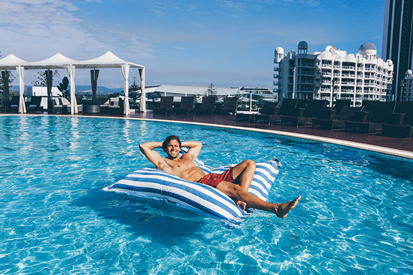Man enjoying some pool time at Sofitel Gold Coast Broadbeach