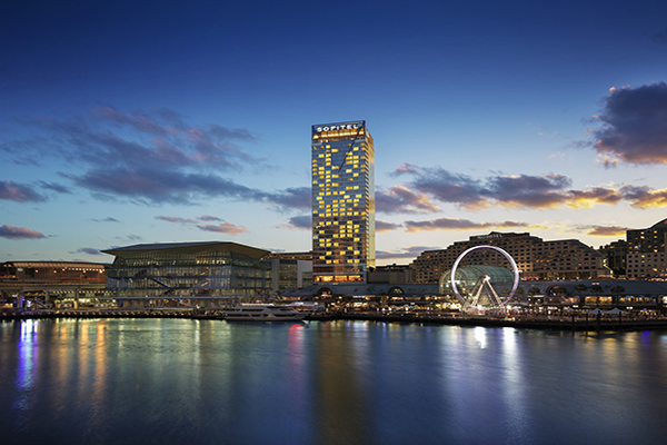 Sofitel Sydney Darling Harbour towers over the city and the water - a perfect, exciting holiday with kids in Sydney