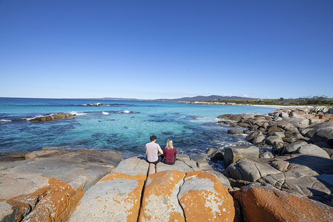 Friends looking out across the ocean in Tasmania 