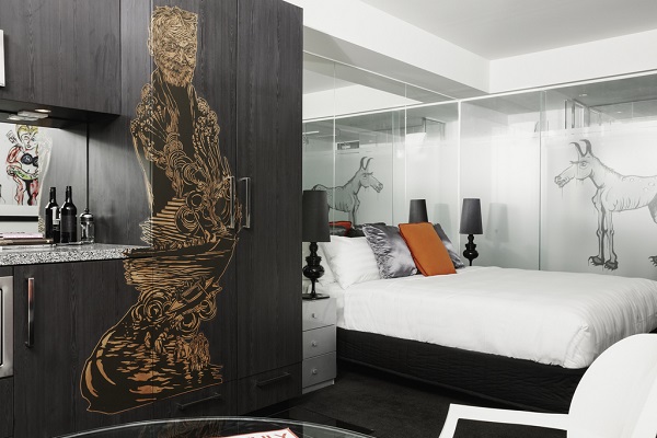 A bedroom at the Cullen hotel in Melbourne with art on the walls