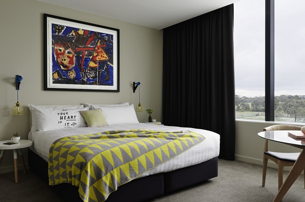 A bedroom at the Larwill with colourful accents