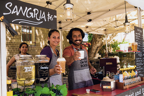 Stall owners with beverages at The Rocks Friday Foodie Market.