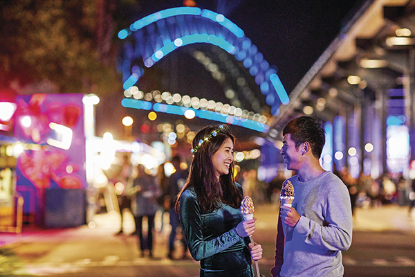 Couple enjoying an ice-cream on a night our during Vivid Sydney.
