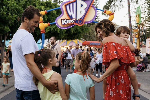 A FAMILY WALKING THROUGH THE STREETS OF WARNER BROS. MOVIE WORLD ON THE GOLD COAST