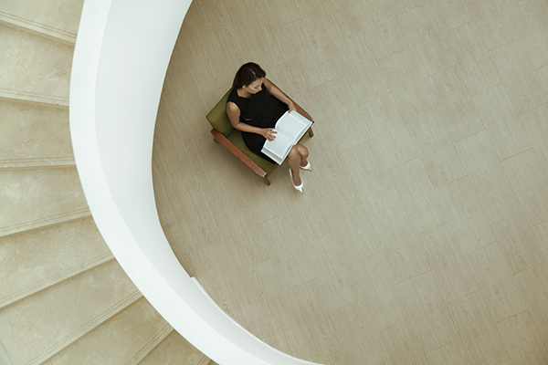 Woman relaxing with a good book in a hotel lobby